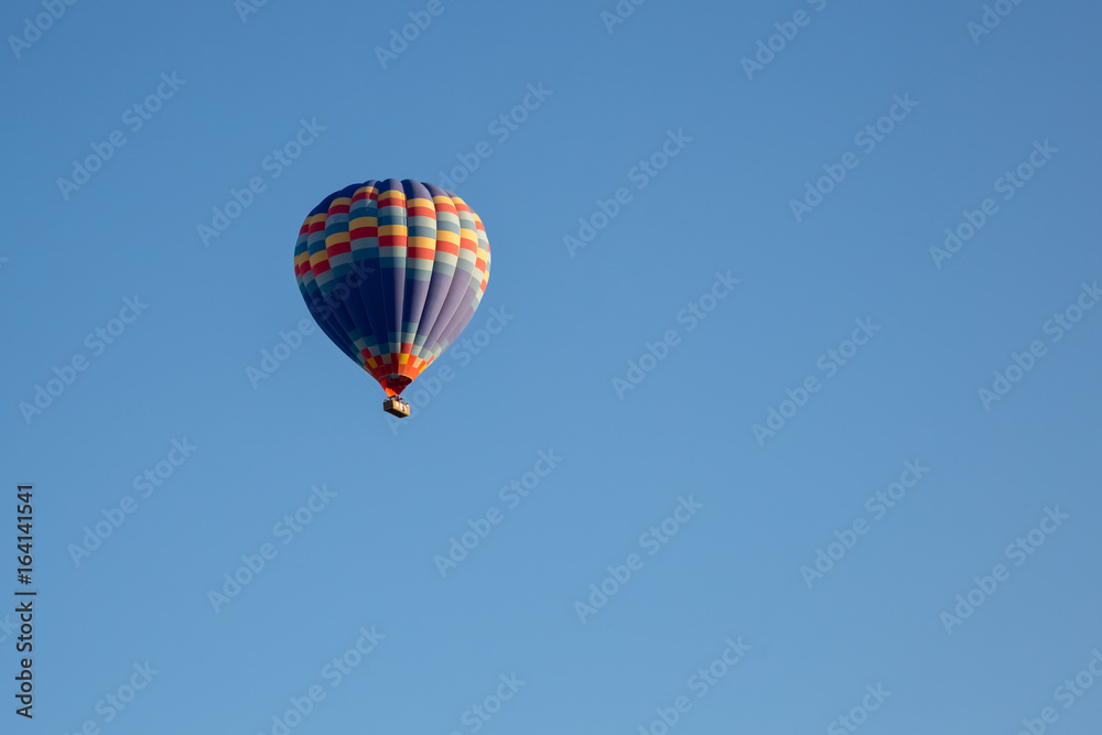 Hot air balloon flying over spectacular Cappadocia Hot air balloon flying over spectacular Cappadocia