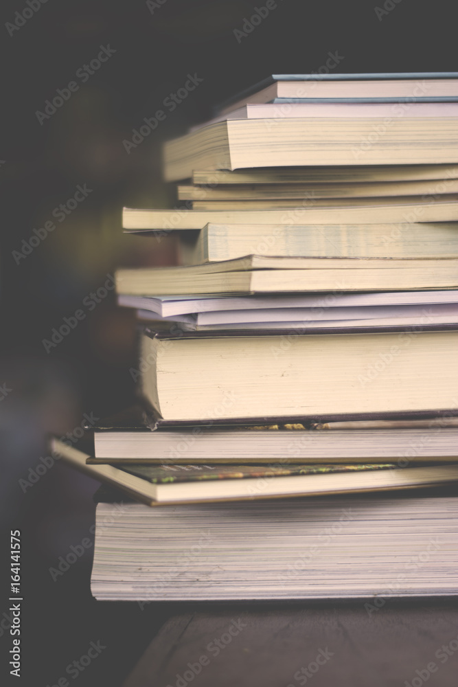 close up on book stacks with dark blurred background on vintage tone close up on book stacks with dark blurred background on vintage tone