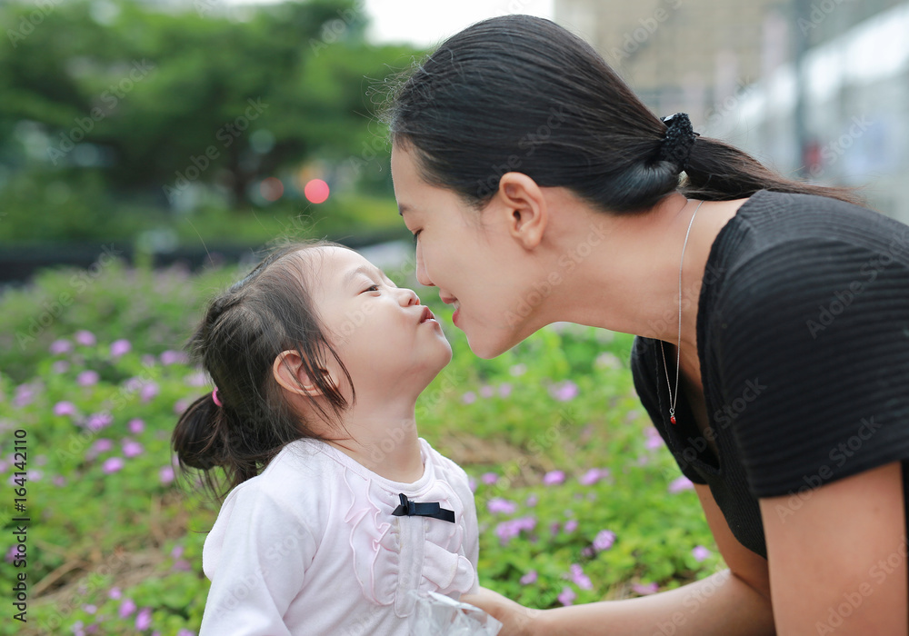 Mother and child girl kissing on bubble gum. Happy loving family. Mother and child girl kissing on bubble gum. Happy loving family.