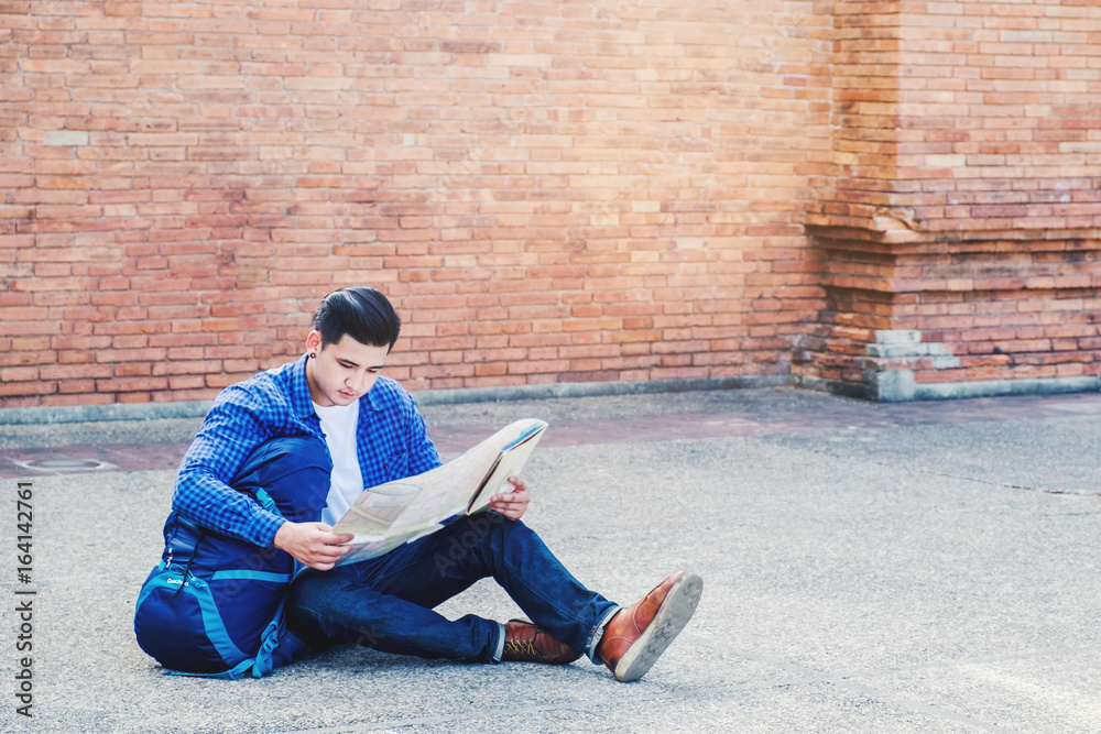 travel man trendy look searching direction on location map while traveling in city during vacation