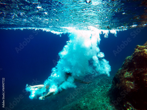 Принти на полотні Man jumped into the water making lot of air bubbles