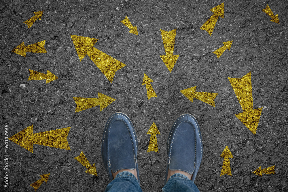 man standing on road with many direction arrow choices or move forward. concept solution and start. man standing on road with many direction arrow choices or move forward. concept solution and start.
