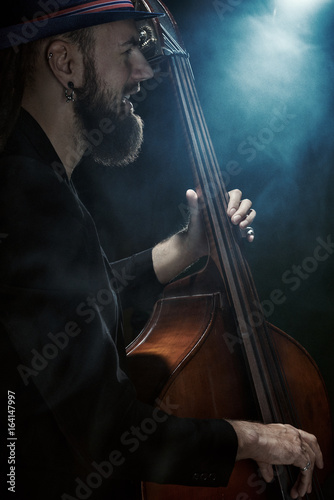 The musician plays the double bass.