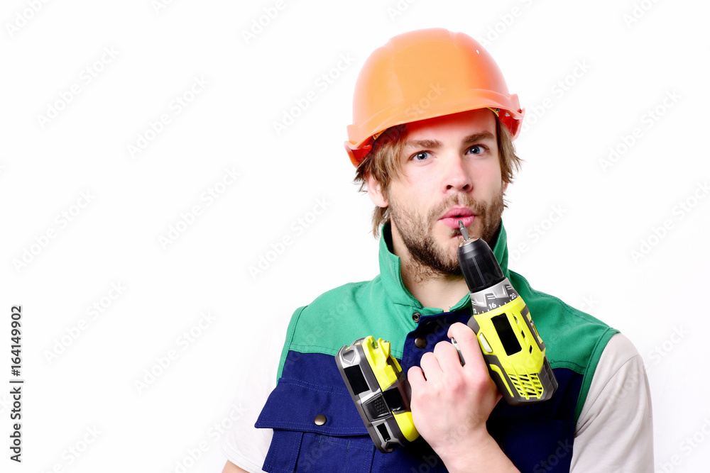 Builder in orange helmet and uniform. Man with concentrated face Builder in orange helmet and uniform. Man with concentrated face