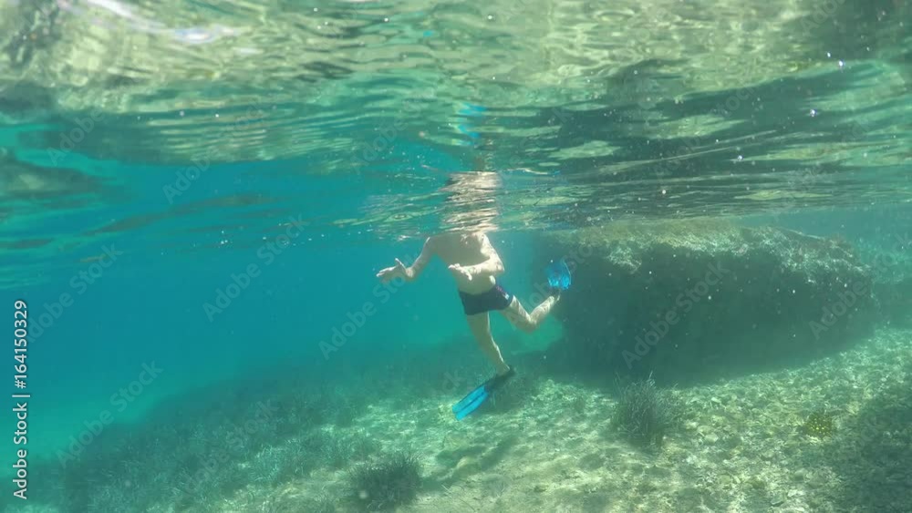 swimmer in flippers dives into the sea, raw, 4K swimmer in flippers dives into the sea, raw, 4K
