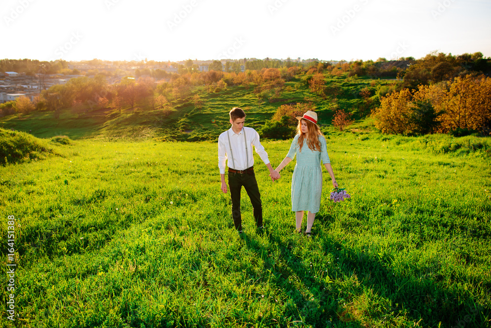 A young man walks with his girlfriend in the park A young man walks with his girlfriend in the park