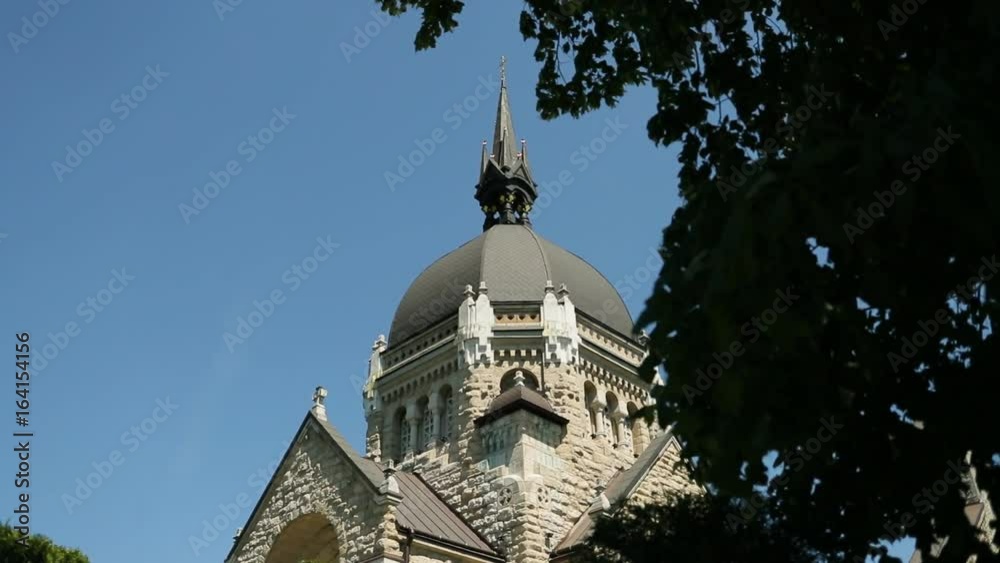 View of church fasad on the blue sky background. View from the side.