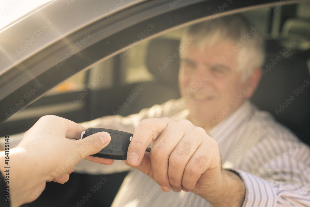 Senior man holding a car key.