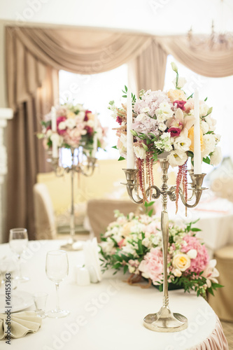 Beautiful decoration on wedding table with roses in bouquet