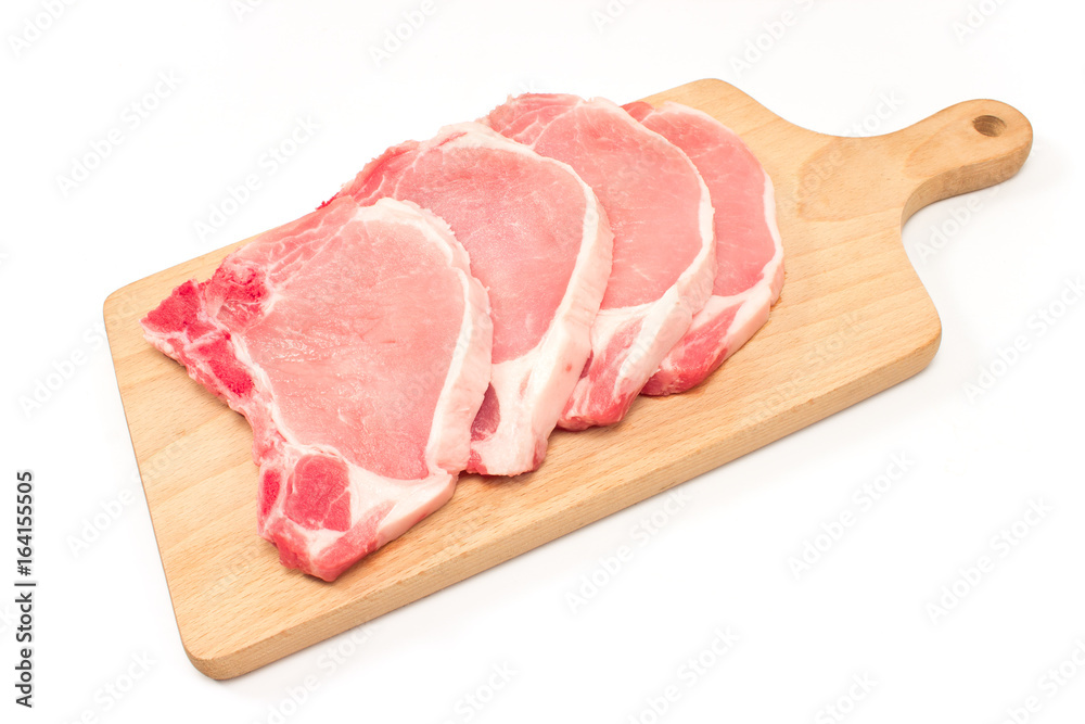 Raw pork chop meat on cutting board isolated on white Raw pork chop meat on cutting board isolated on white