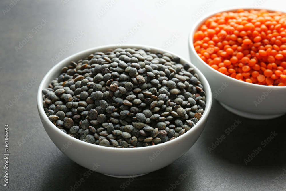 Bowls with red and black lentils on table Bowls with red and black lentils on table