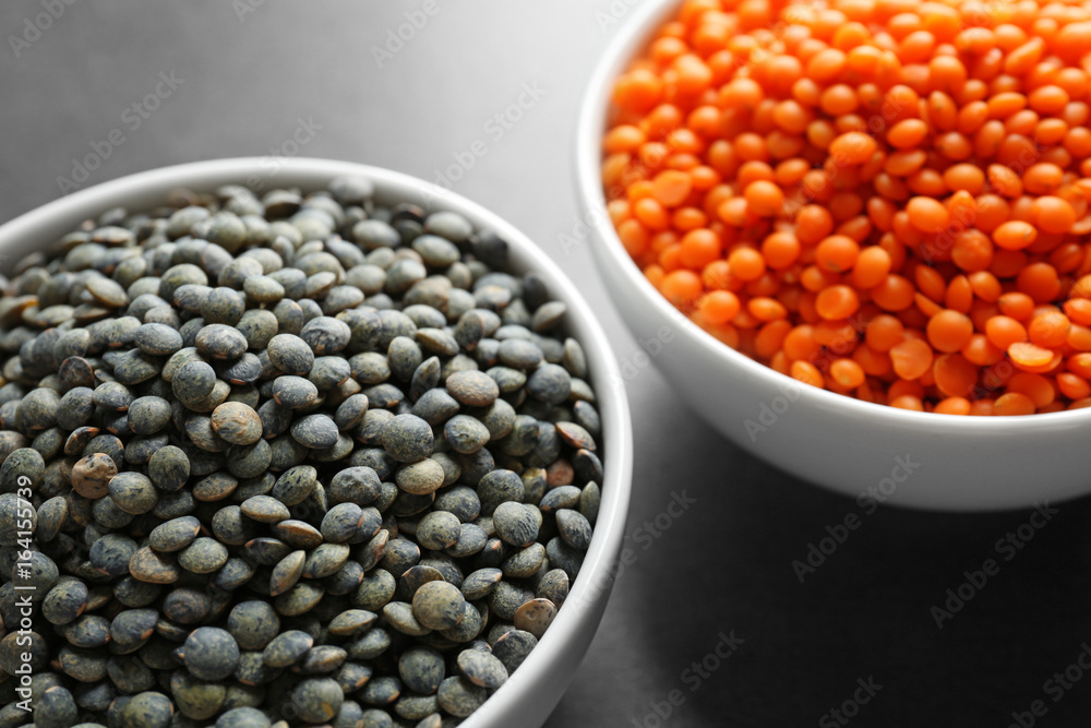 Bowls with red and black lentils on table Bowls with red and black lentils on table