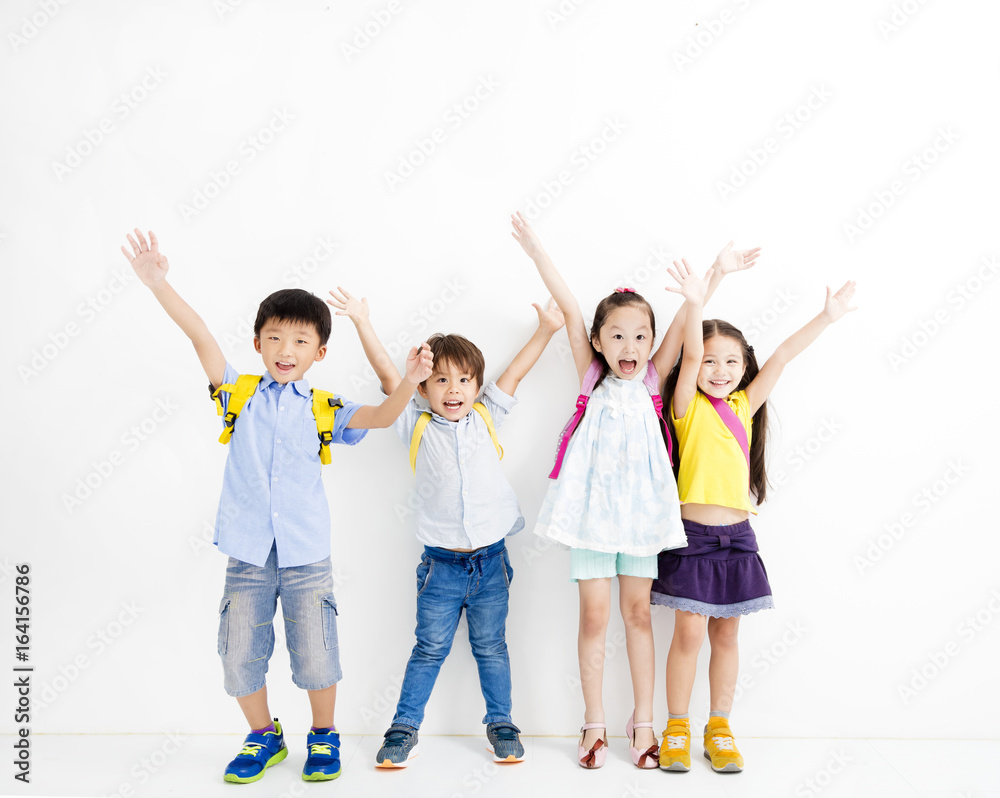 Obraz premium Group of happy smiling kids raise hands