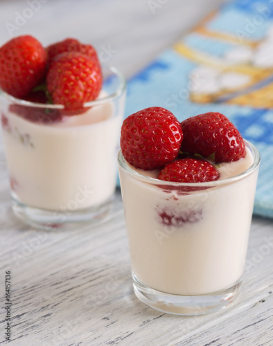 Wallpaper Mural yogurt with strawberries in a glass on wooden table with blue napkin Torontodigital.ca