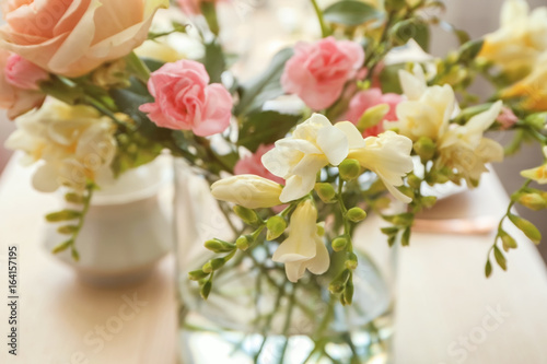Beautiful bouquet of fresh freesia in vase on table © Africa Studio
