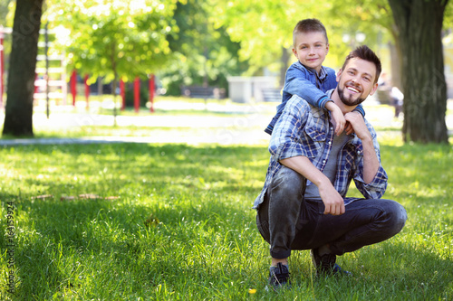 Dad and son in green park o...
