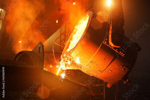 Pouring molten steel in the foundry photo