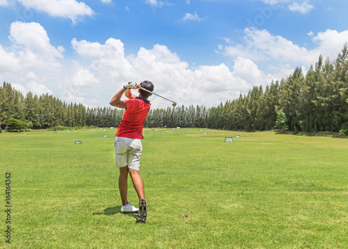 Wallpaper Mural golfer in action hit golf shot on golf course yard signs during practice golf driving range with blue sky Torontodigital.ca