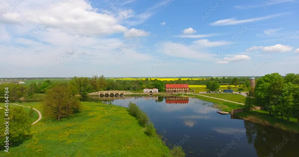 Aerial shot of small, village, park, menor bridge. Menor or Pakruojis, Lithuania Aerial shot of small, village, park, menor bridge. Menor or Pakruojis, Lithuania
