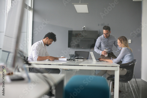 Business people using technology and checking document. Business people at the office.