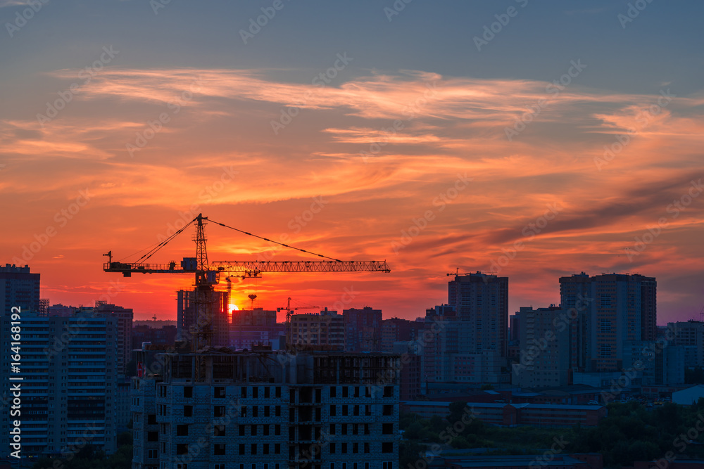 Evening sky against a city landscape with a crane Evening sky against a city landscape with a crane