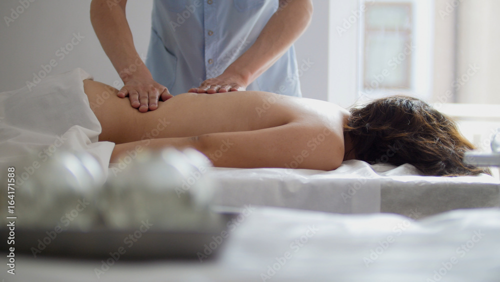 Obraz premium Spa. The girl is given a massage in the lower back