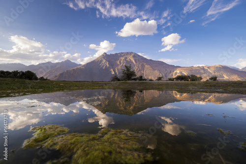 The reflection of mountain and a sunset at sand dune, Nubra valley, Leh Ladakh, India