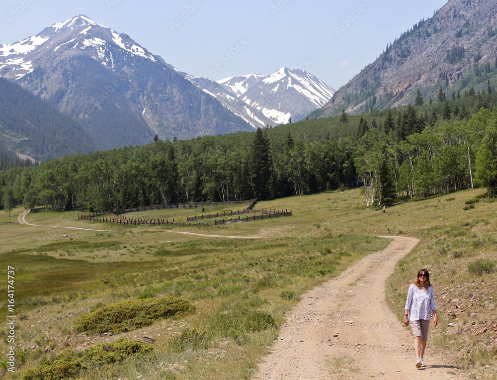 A Woman Walks a Road on the Alpine Loop Backcountry Byway