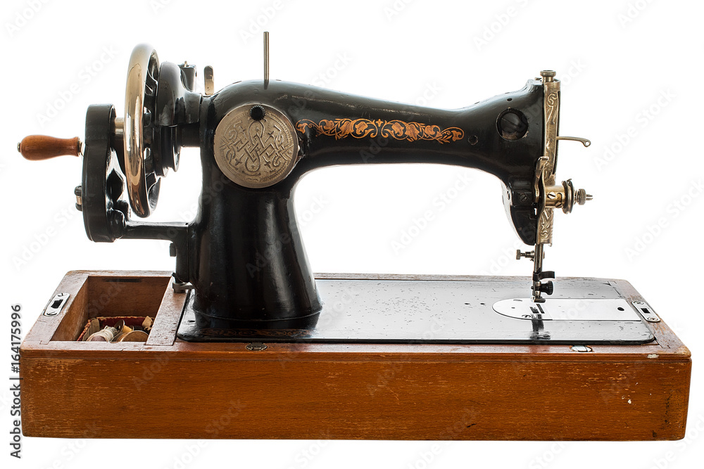 An old, hand sewing machine on white background