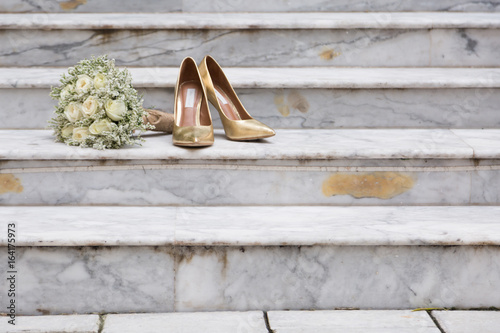 White Rose Bouquet and Gold Wedding Shoes on Marble Steps