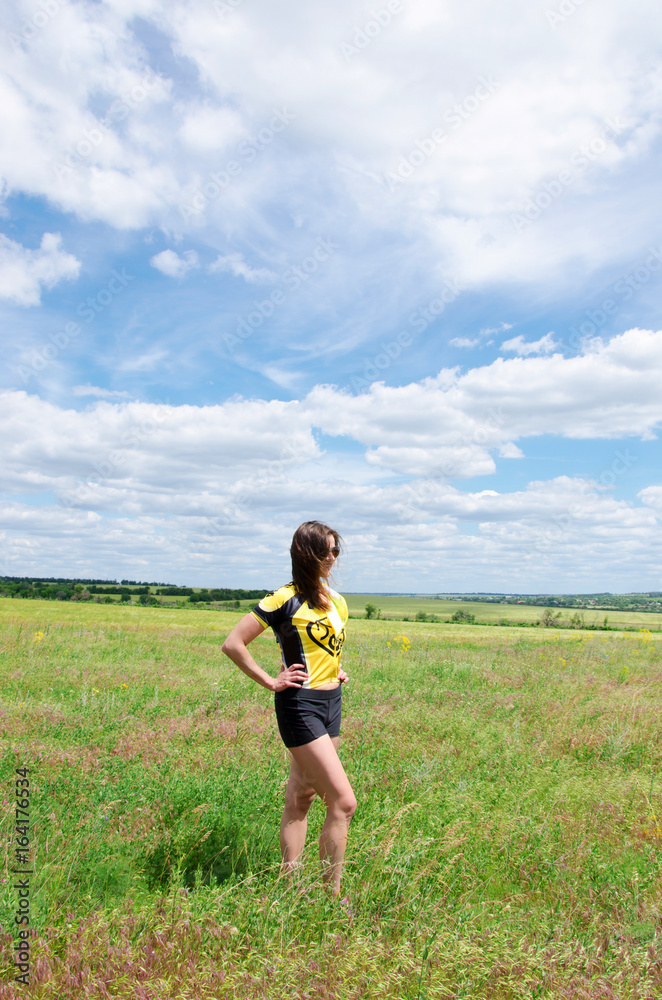girl is standing on the green field girl is standing on the green field