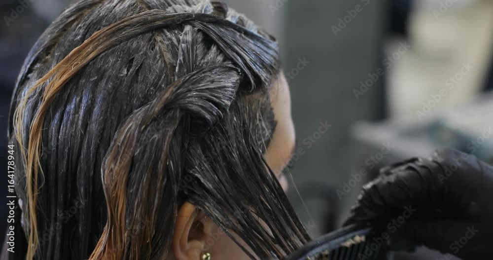 Barber dyeing coloring hair woman girl side view macro close-up hands combing comb grooming haircare salon beauty fashion hairdresser process tint roots tinting modern new color hairdo glove gloves Barber dyeing coloring hair woman girl side view macro close-up hands combing comb grooming haircare salon beauty fashion hairdresser process tint roots tinting modern new color hairdo glove gloves
