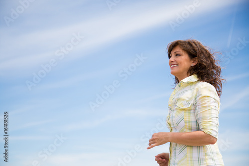 Middle aged woman walking on the beach
