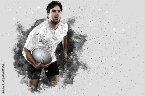 Rugby player coming out of a blast of smoke.