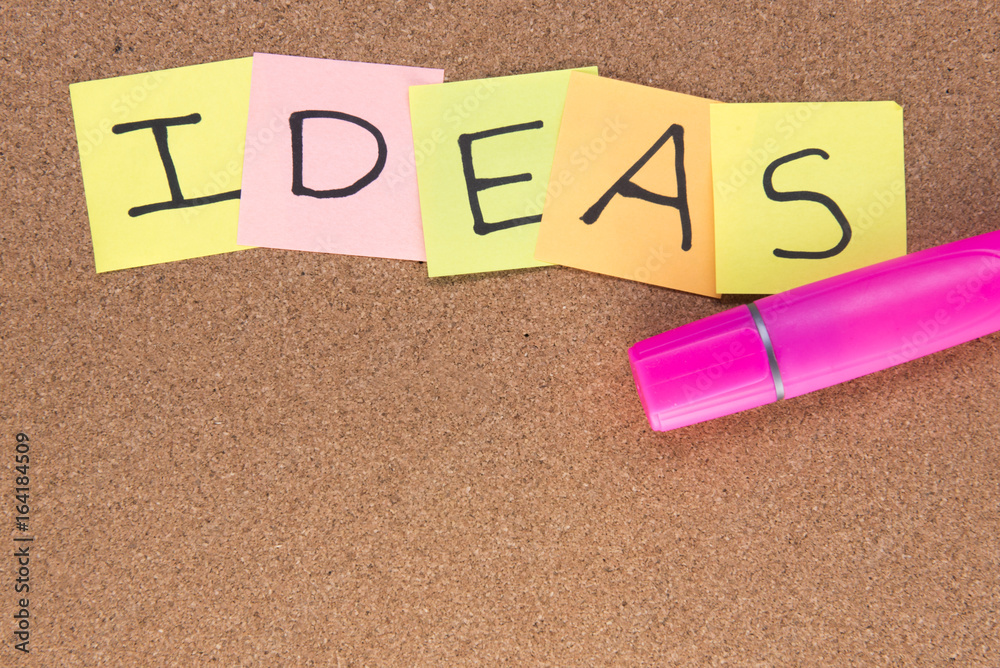 Ideas written on post it notes with a pink highlighter, taken on a wooden background with copy space Ideas written on post it notes with a pink highlighter, taken on a wooden background with copy space