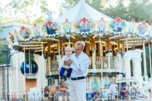 Tablou canvas Happy father and little son playing and having fun in amusement park