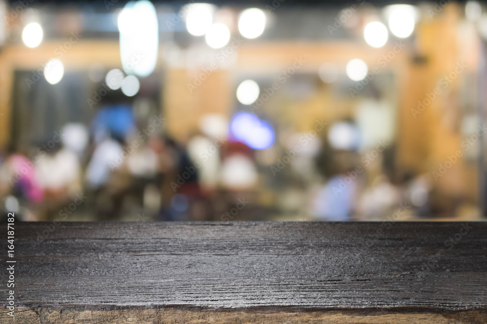 Empty wooden table for present product on coffee shop or soft drink bar blur background with bokeh image