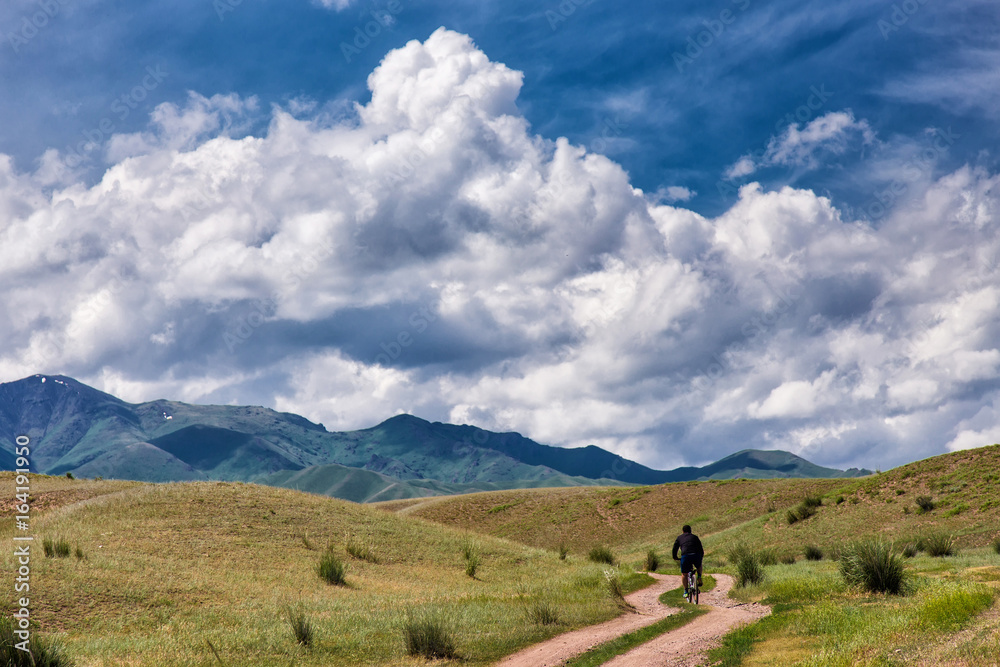 A cyclist is traveling in the mountains A cyclist is traveling in the mountains