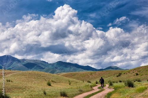 A cyclist is traveling in the mountains