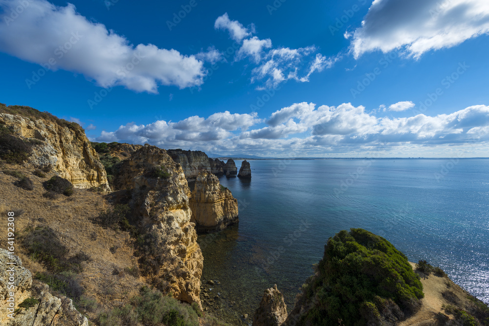 View of the sandstone cliffs at the Ponta da Piedade and the Lagos bay in Algarve, Portugal; Concept for travel in Portugal and Algarve View of the sandstone cliffs at the Ponta da Piedade and the Lagos bay in Algarve, Portugal; Concept for travel in Portugal and Algarve
