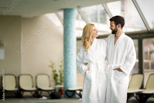 Beautiful cheerful couple relaxing in spa center