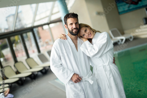 Beautiful cheerful couple relaxing in spa center