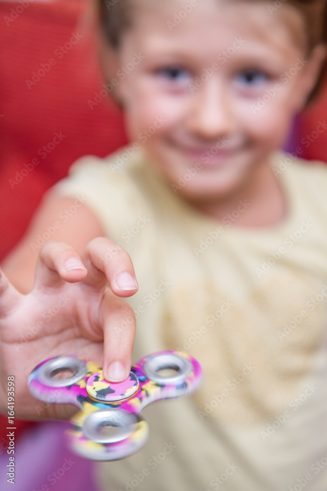 Cute young girl playing with fidget spinner Cute young girl playing with fidget spinner