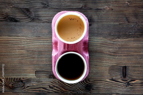 Coffee take away. Coffee cups with covers on wooden table backound top view copyspace photo