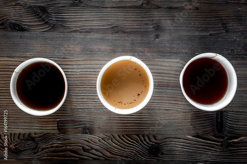 Coffee take away. Coffee cups with covers on wooden table backound top view copyspace photo