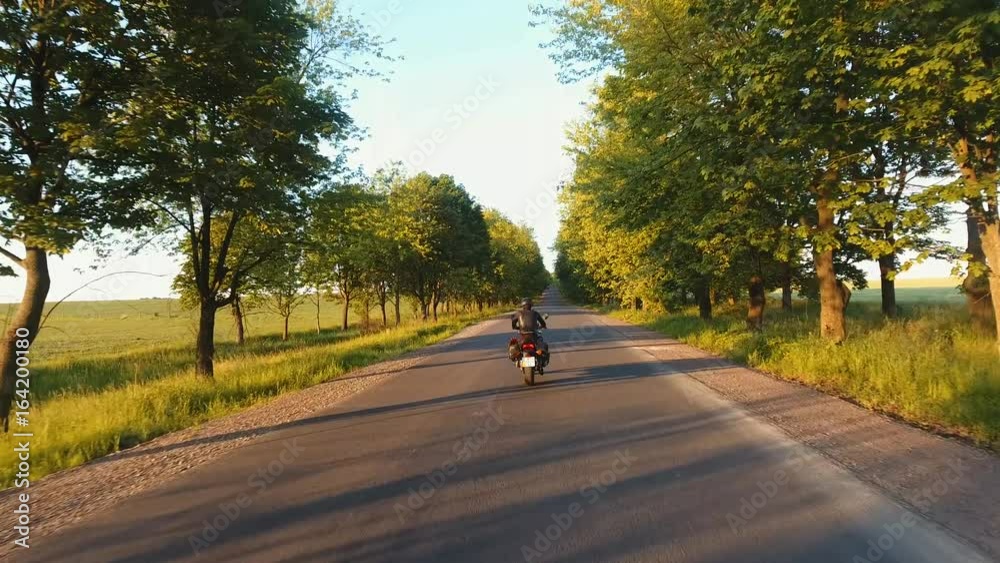Aerial: the hills of the Carpathians, the camera follows a motorcyclist on the highway, having fun and enjoying the road Aerial: the hills of the Carpathians, the camera follows a motorcyclist on the highway, having fun and enjoying the road