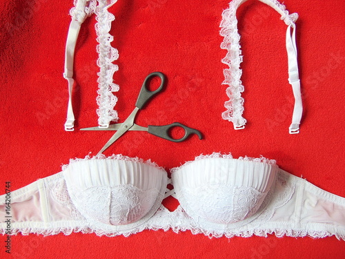 White lace strapless bra with scissors cutting the straps