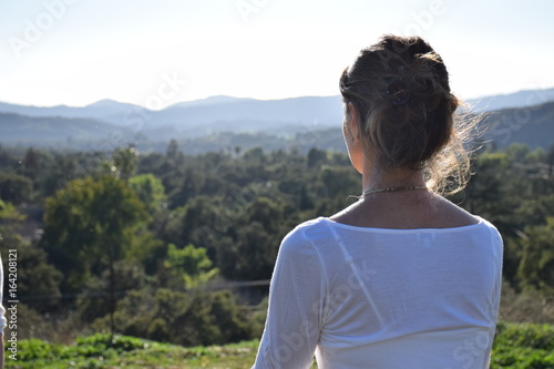 Woman overlooking Valley on Mountain