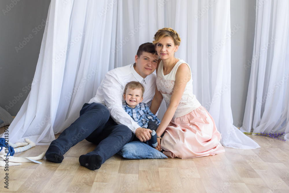 portrait of happy family of three indoors