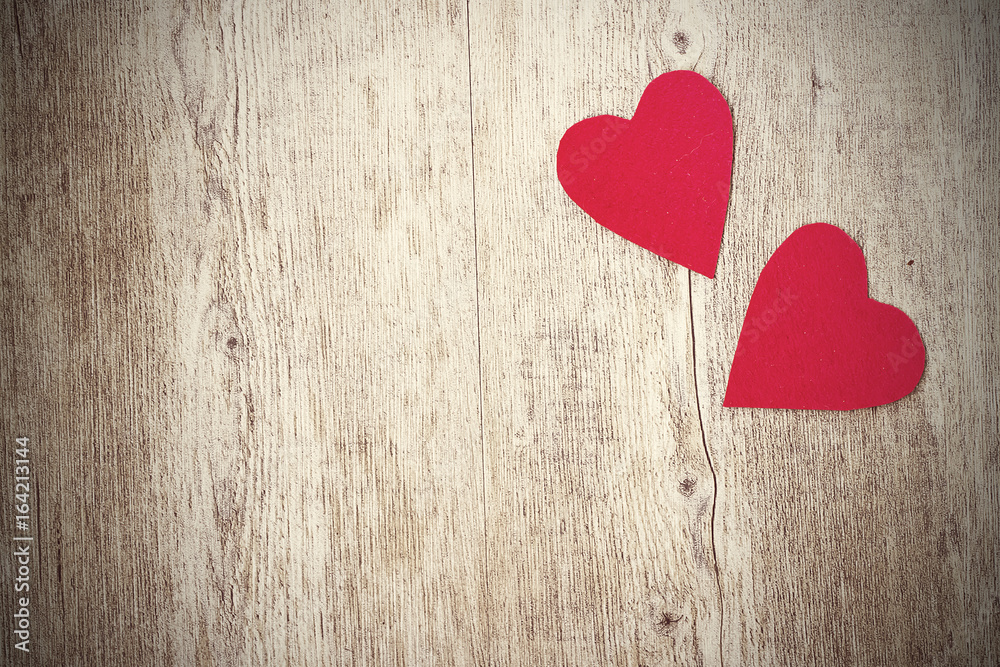Two red hearts on a wooden background. Copy space. Two red hearts on a wooden background. Copy space.